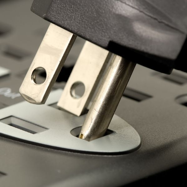 plugging in a cord to an outlet plugging in a cord to an outlet