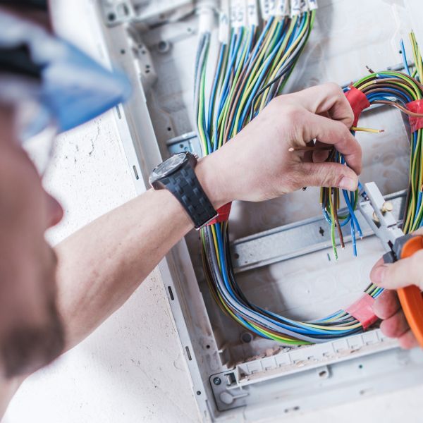 electrician working on electrical panel