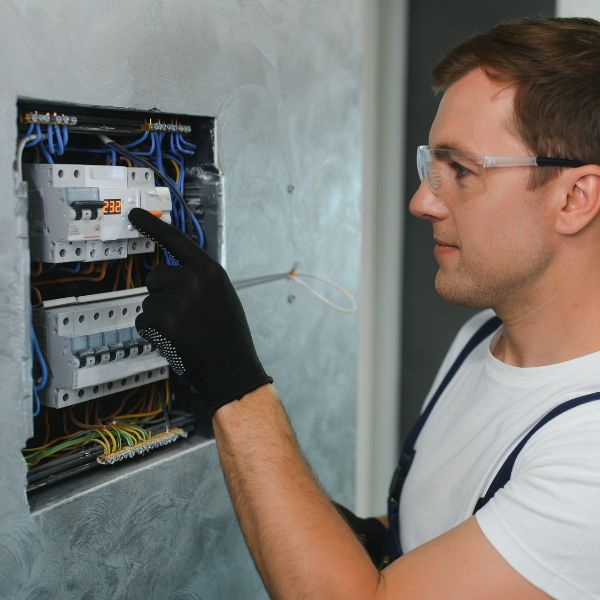 electrician looking at circuit breaker