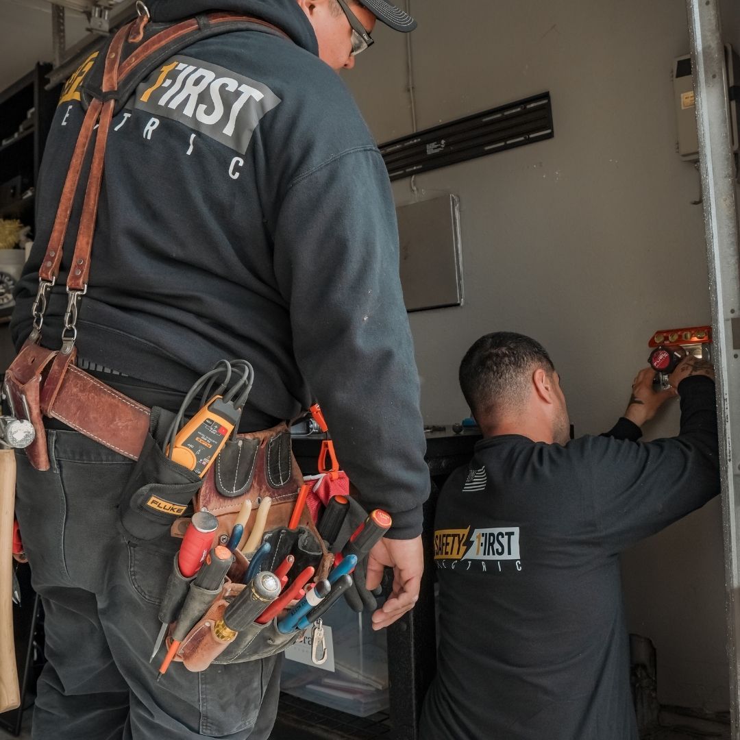 electricians at work in home garage 
