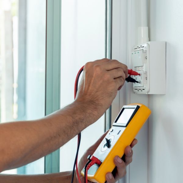 electrician checking outlet