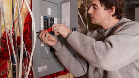 electrician working on electrical panel