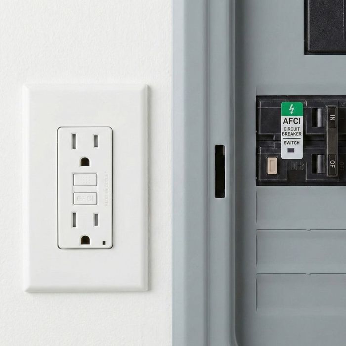 A close-up view shows a standard GFCI outlet next to a new AFCI circuit breaker switch.