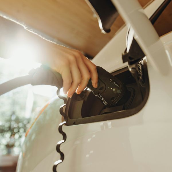 plugging charger into electric vehicle