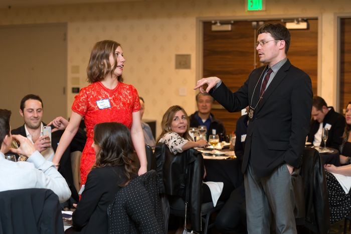 Detective interrogates a guest at a mystery dinner