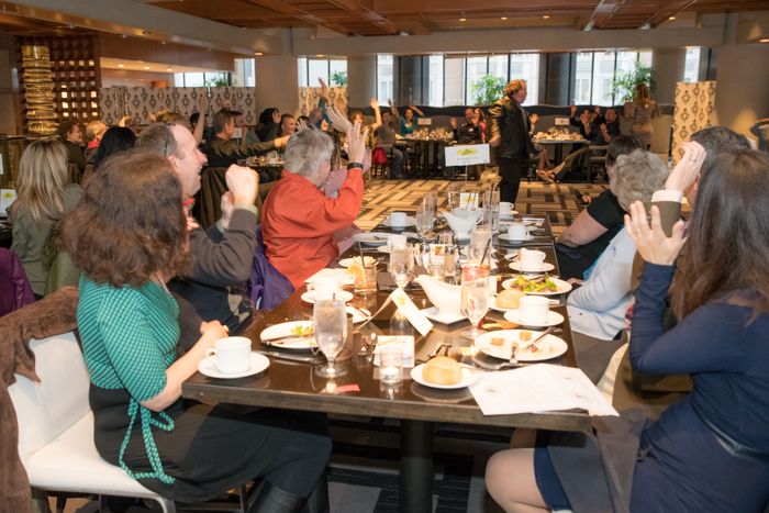 Guest laughing at a Dinner Detective murder mystery event