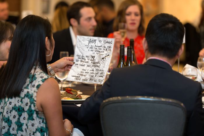 Guests examining clues at a mystery dinner show