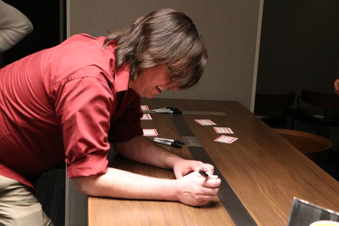 Guest at check-in table writing name tags