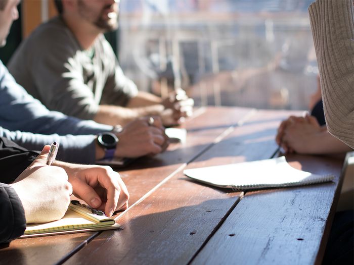 A group of people discussing business.