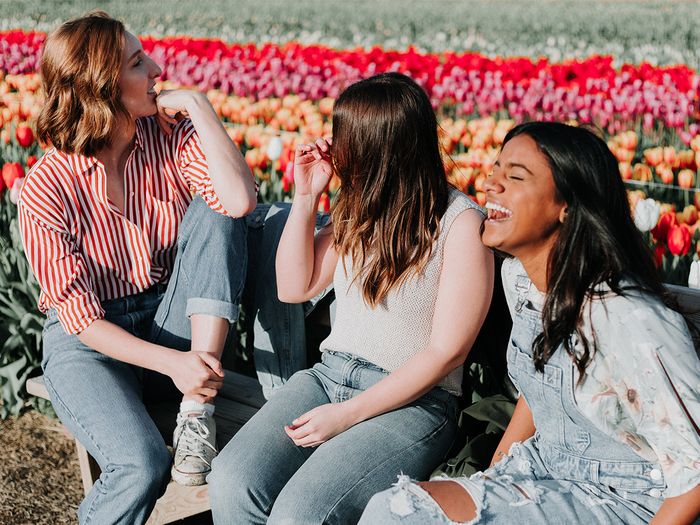 A diverse group of women laughing.