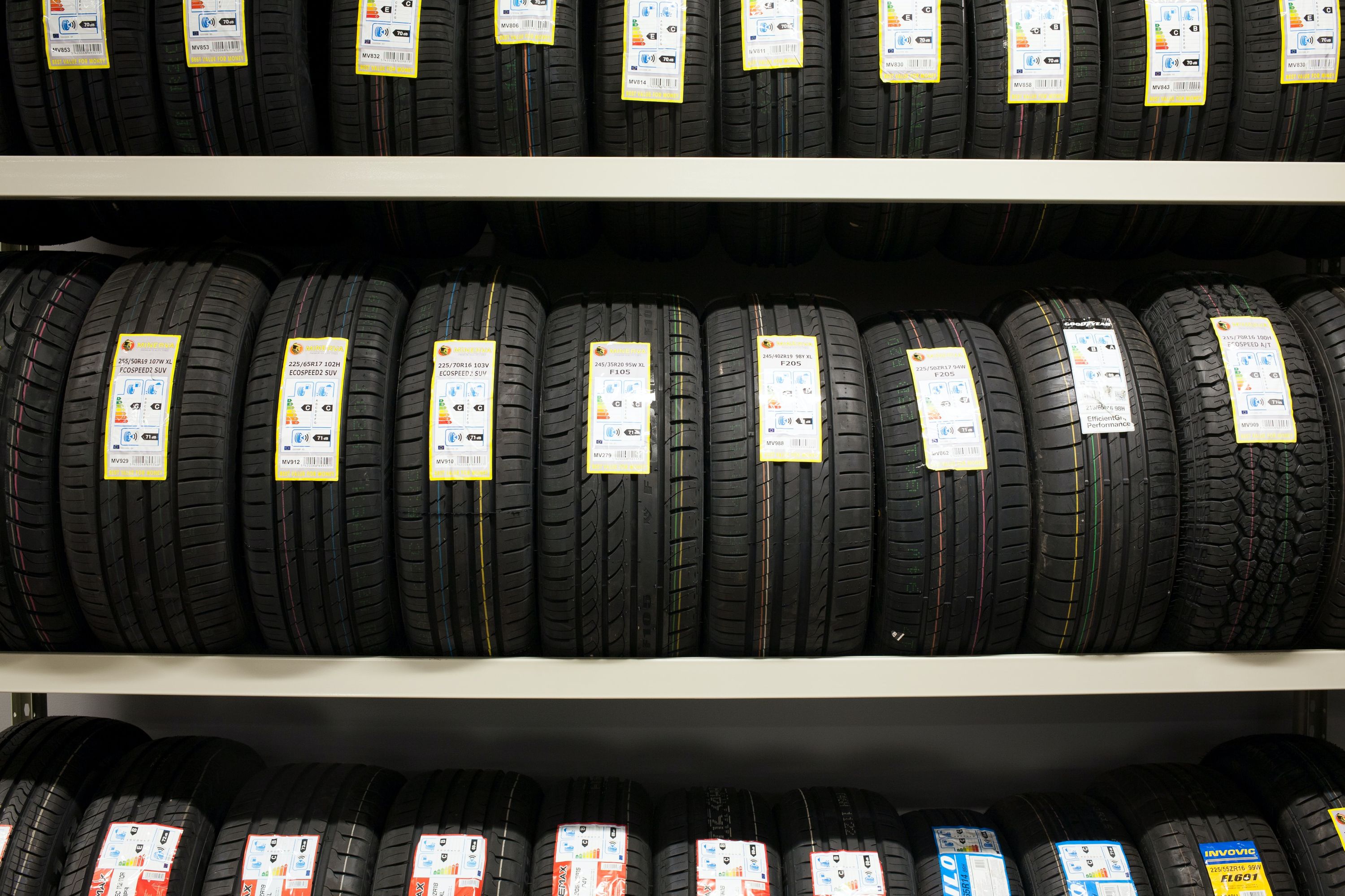Image of new tires sitting on a shelf.