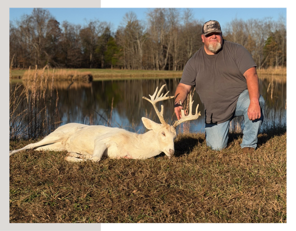 A hunter and whitetail deer.