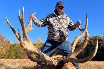 A man with a whitetail deer.