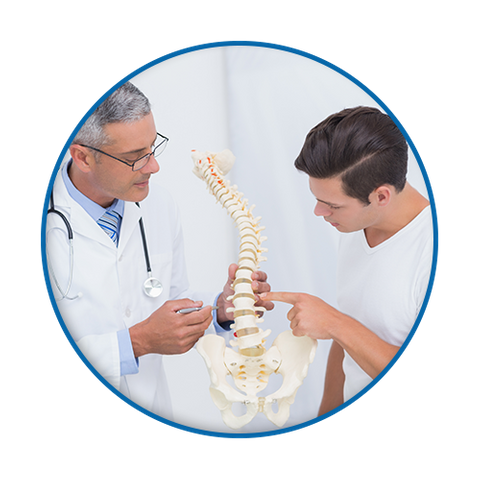 photo of patient looking at spine model with chiropractor