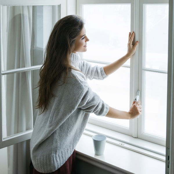 woman opening a window