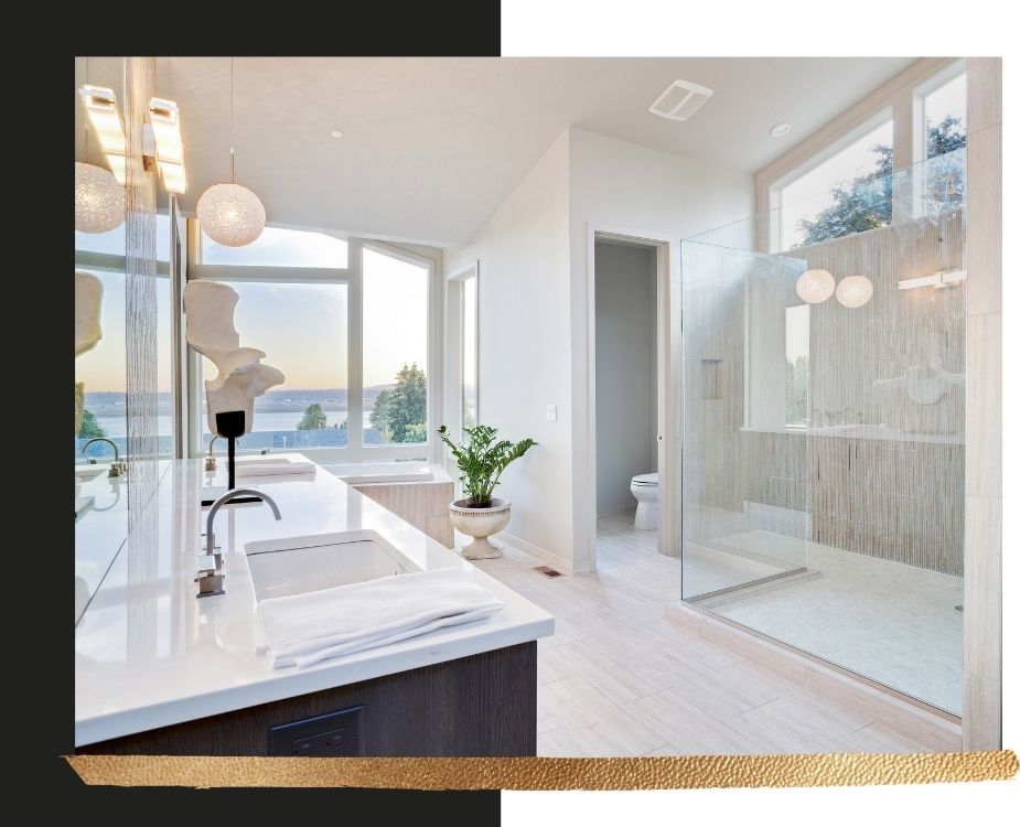 High-end bathroom vanity area with white quartz countertops, under-mount sinks, and a large glass-enclosed shower with vertical accent tiling.