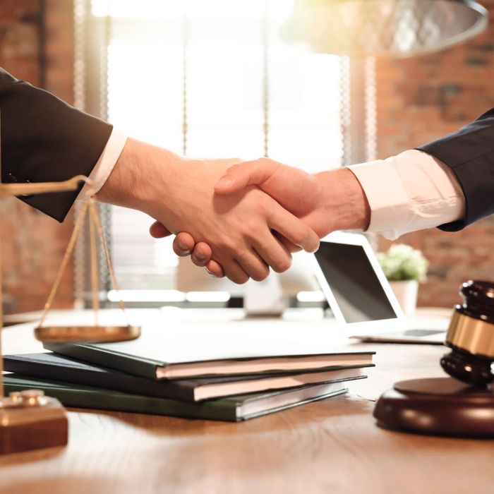 client and lawyer shaking hands