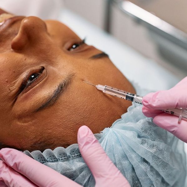 botox being injected into a woman's forehead