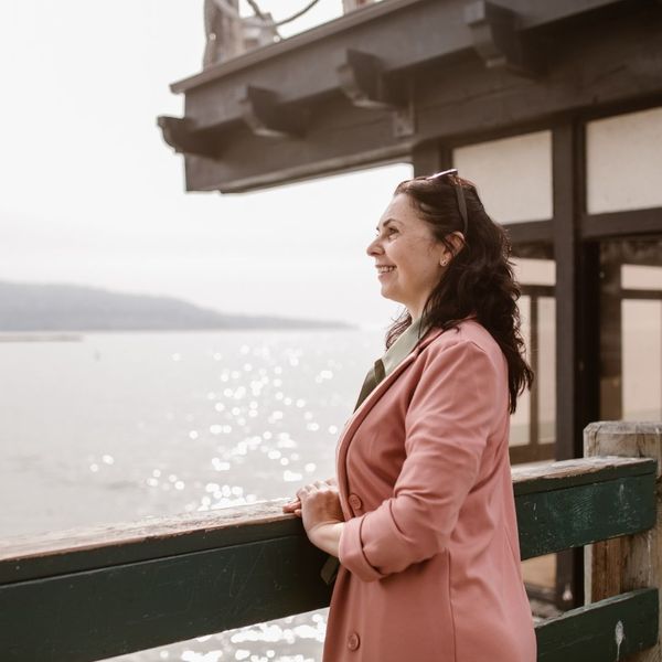 middle aged woman looking at a view and smiling