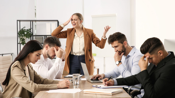 Group of 5 workers looking stressed and overwhelmed