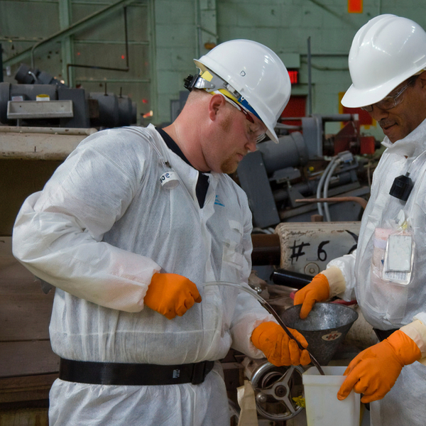 image of two men in safety gear at a factory.jpg