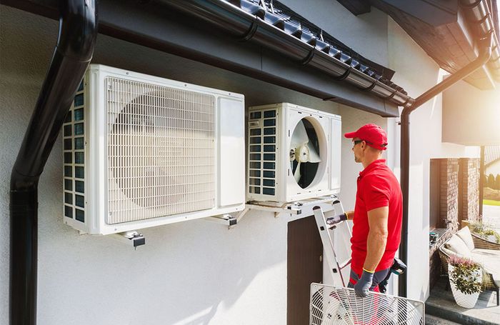 HVAC technician working on commercial unit