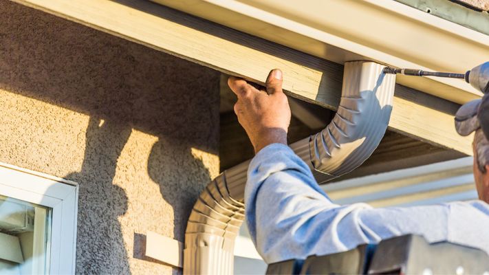 Person installing a gutter