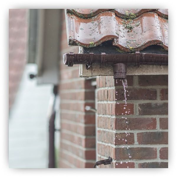 Copper gutter under a tile roof