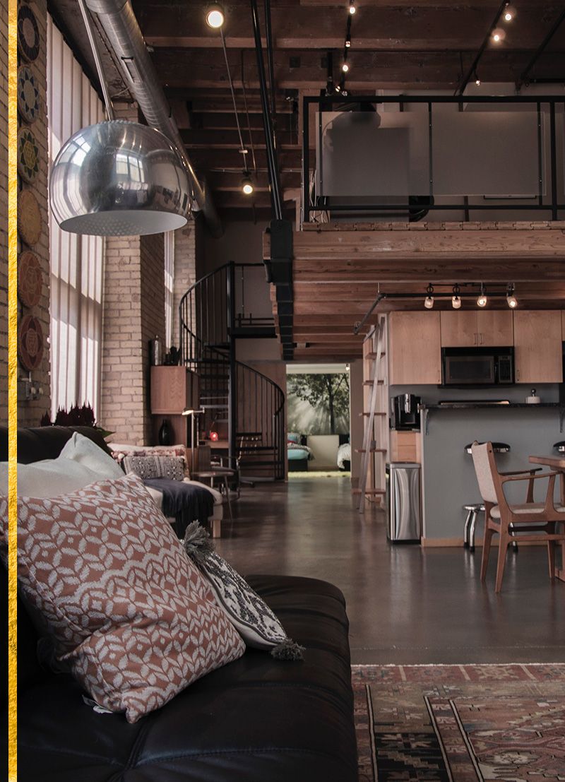 Image of a couch with cute pillows and the inside of an apartment 