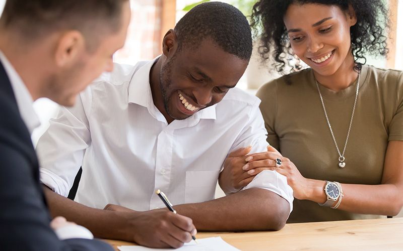 Image of a man and woman signing documents