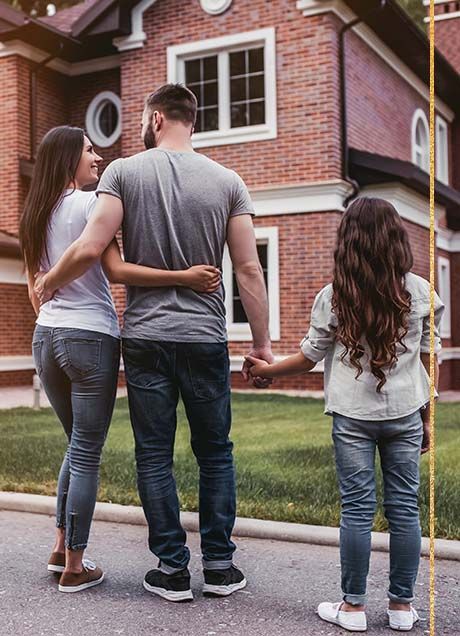 Happy family in front of home