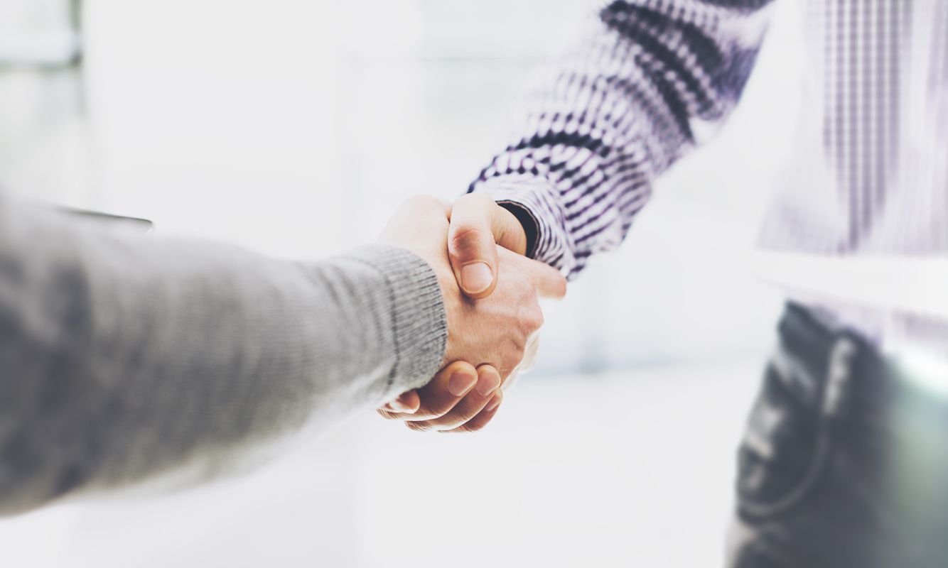 Image of two men giving each other a handshake