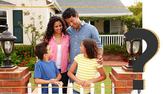 Happy family in front of home