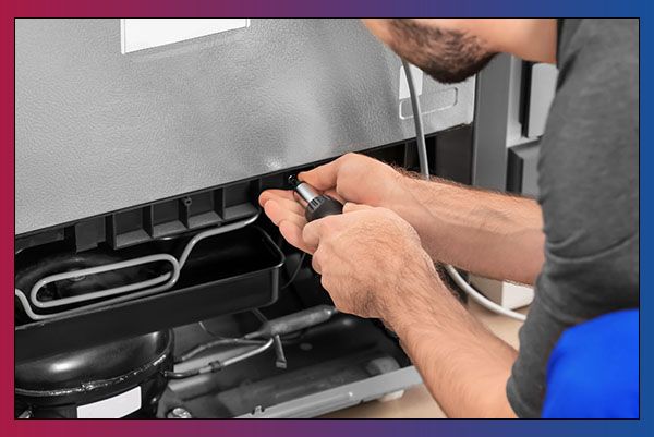 HVAC worker fixing refrigerator 