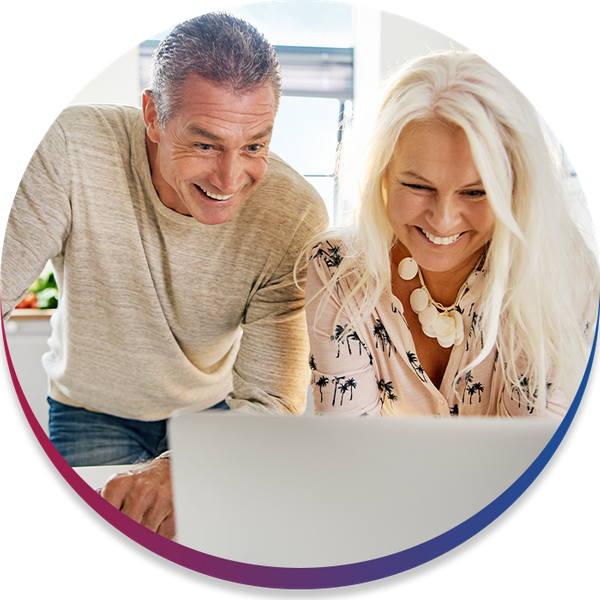 Image of an older couple looking at a computer getting a quote and smiling