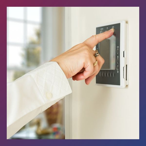 a woman chaning her thermostat Blog Img 2.jpg
