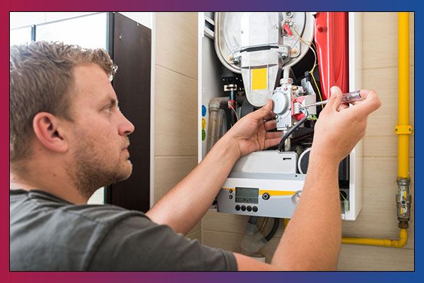 HVAC Employee working on heat furnace