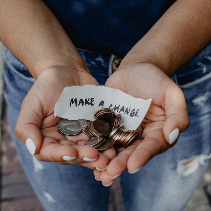 Woman holding note saying 'Make a change'