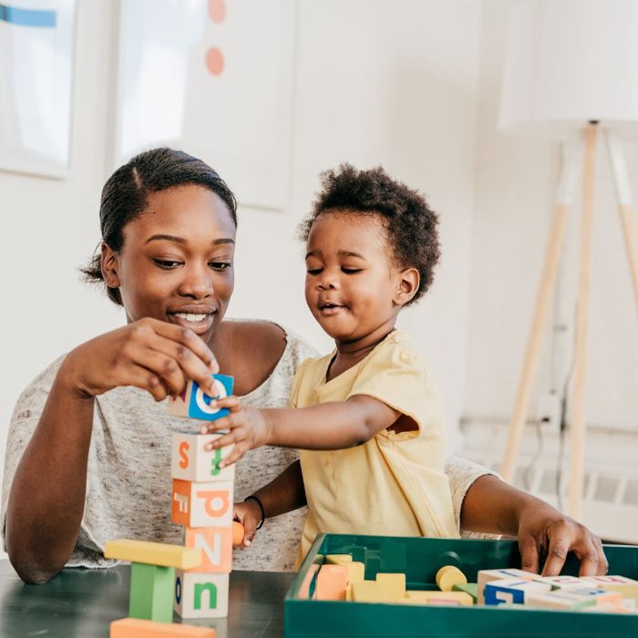 Pediatric Therapist and a child engaging in a motor activity.