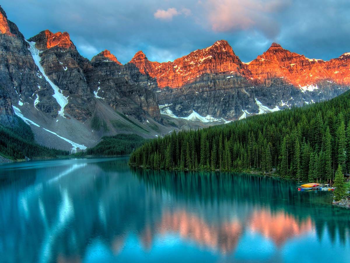 Mountains reflected over a clear lake.