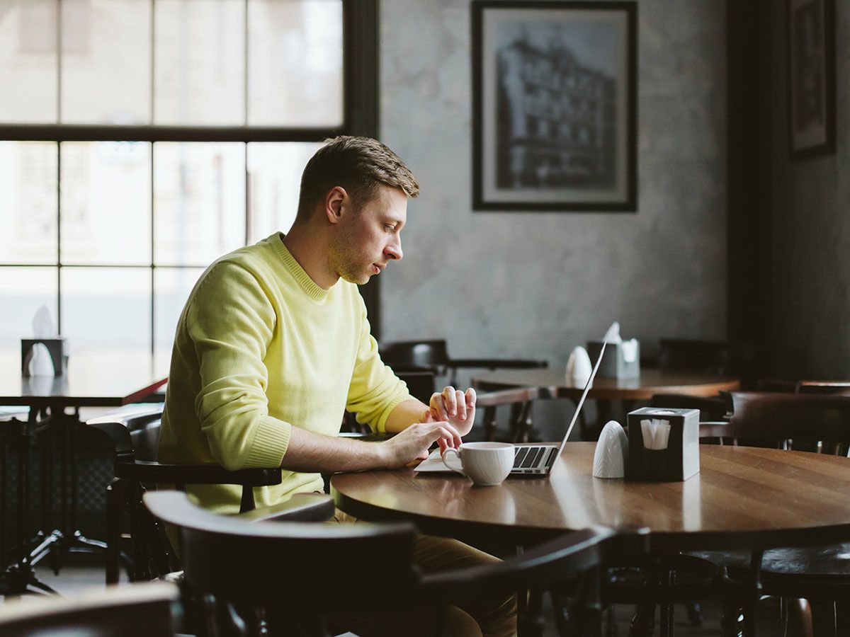 Man on computer in a coffee shop