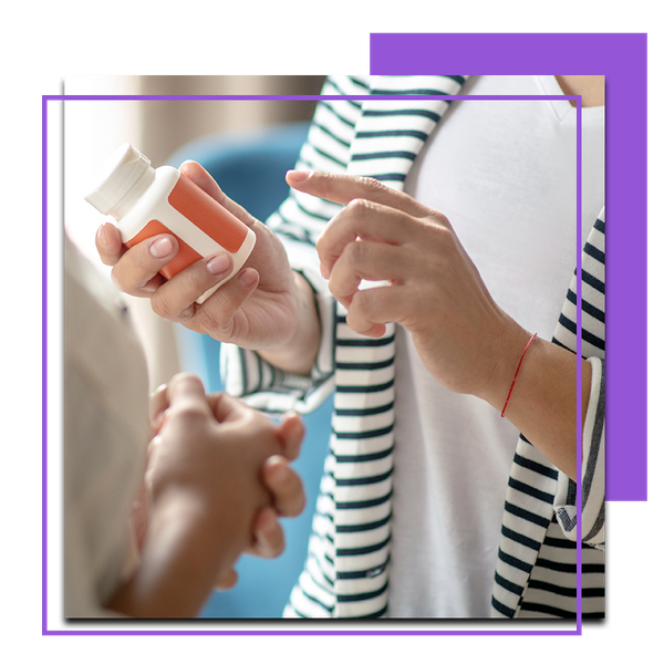 Image of a woman holding a bottle of pills