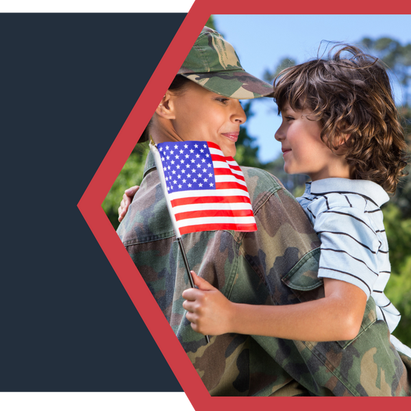 female veteran holding a little boy holding an american flag