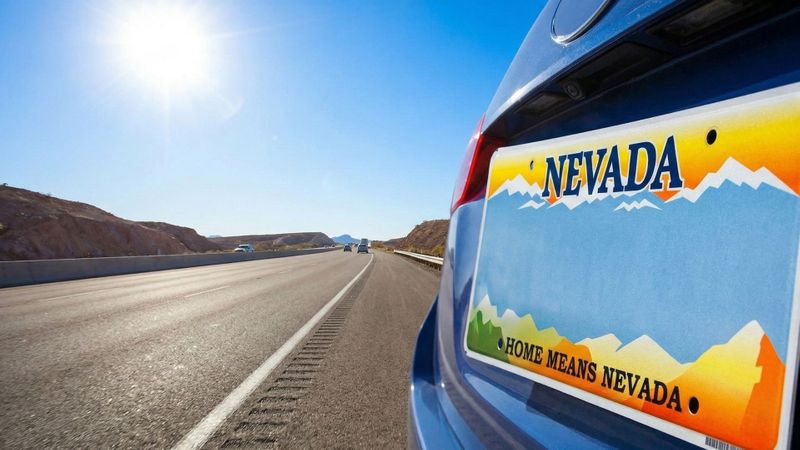 Car with Nevada license plate on a road. Car with Nevada license plate on a road.
