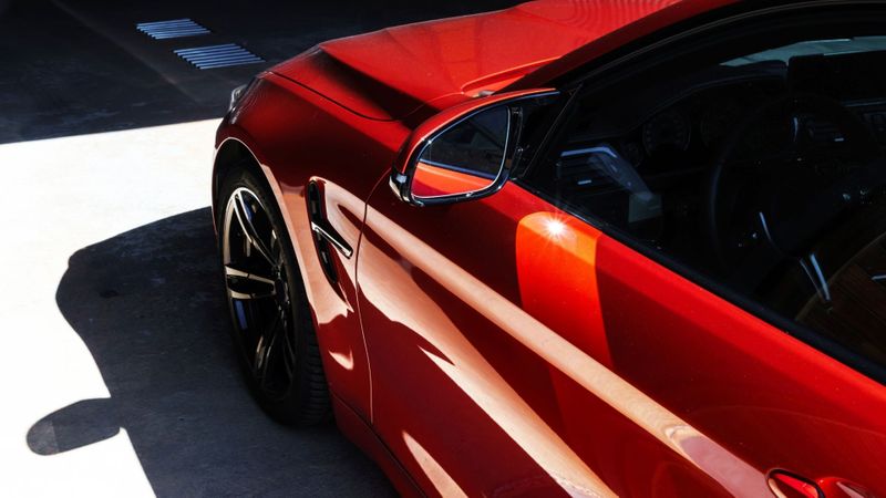 A parked red car. A parked red car.