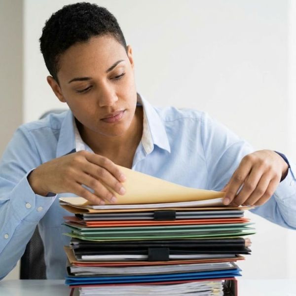 A woman going through paperwork.