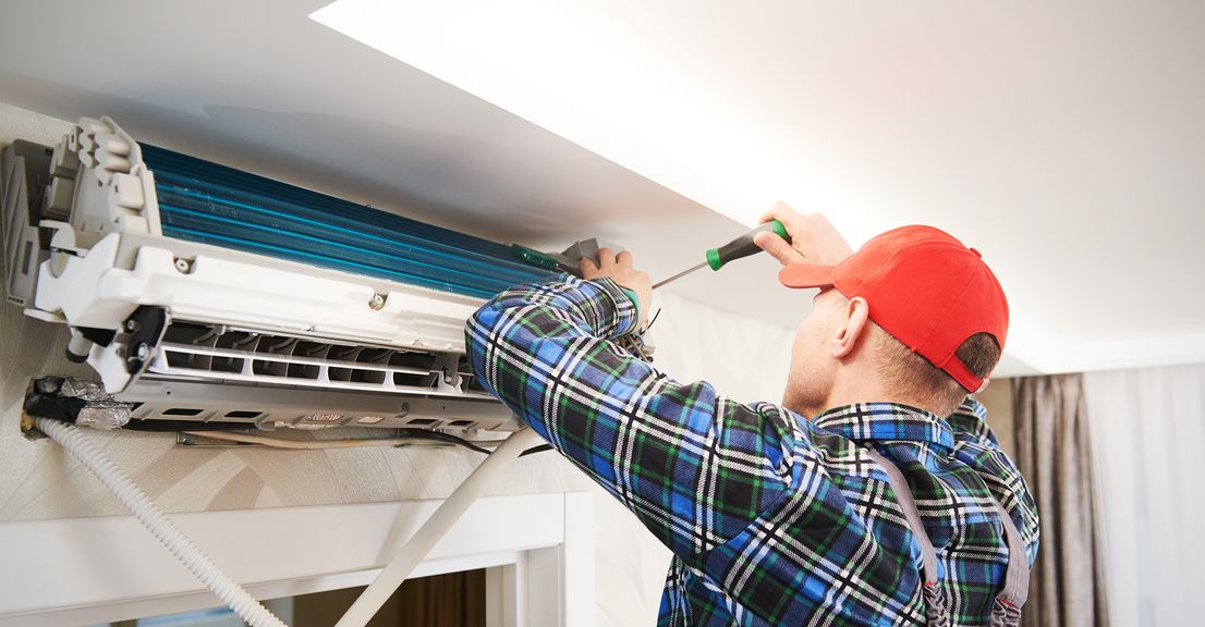 A HVAC professional installing an air conditioning system