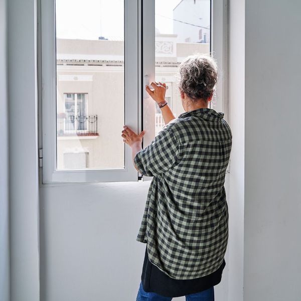 woman opening or closing a window