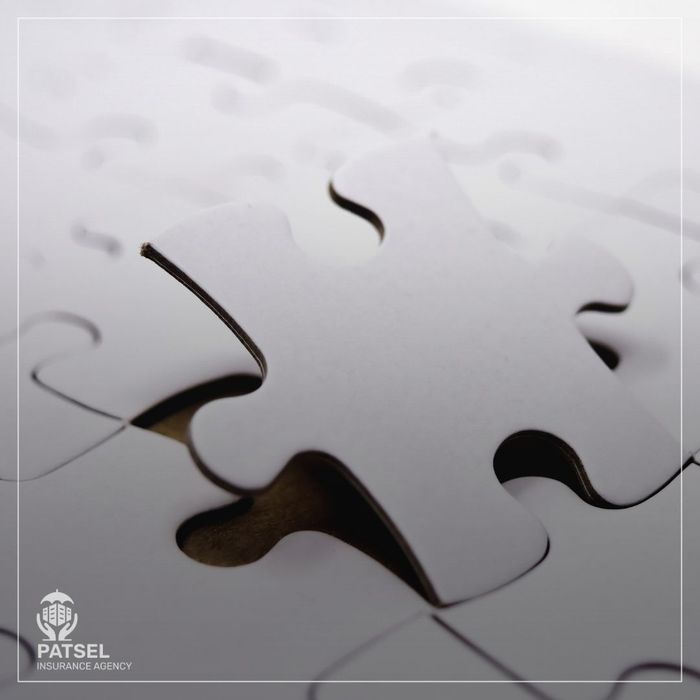 Two puzzle pieces fitting together perfectly, symbolizing complete insurance coverage without gaps.