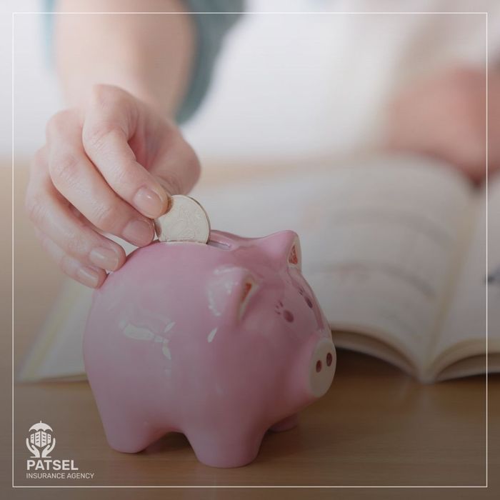 hand putting coin into piggy bank